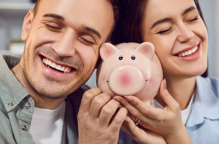 Couple holding a piggy bank