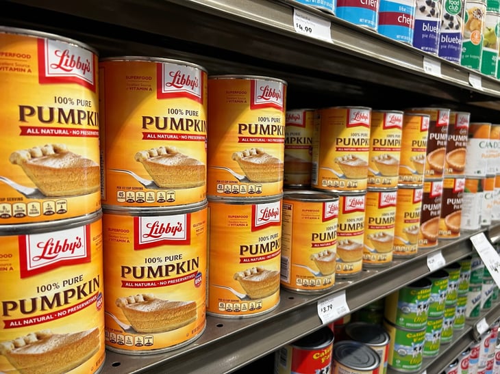 Grocery store with shelf of canned pumpkin