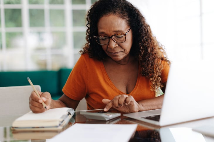 older woman doing calculations