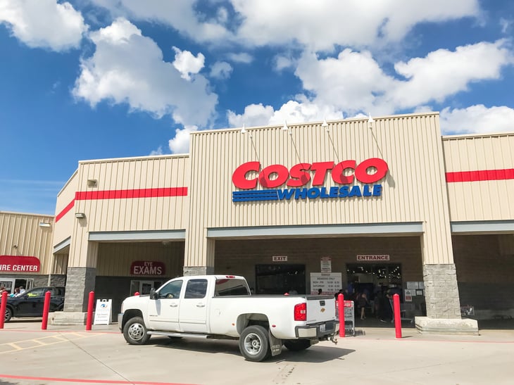 Exterior of a Costco warehouse store with a pickup truck in front 