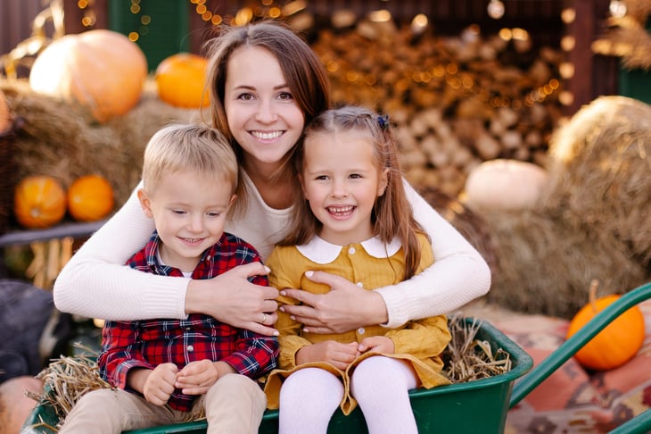 Mother and children in a fall scene
