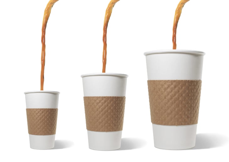 Coffee poured into three sizes of to-go cups