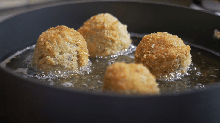 Turkey croquettes frying in a pan for Thanksgiving leftover treat