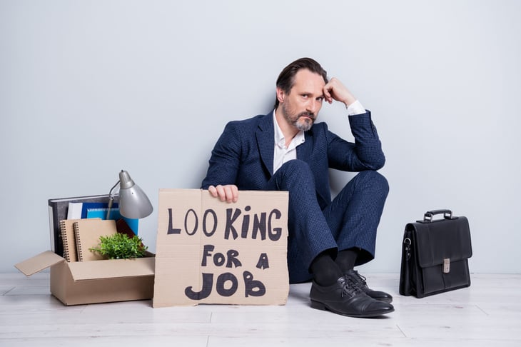 Unemployed worker with "looking for a job" sign
