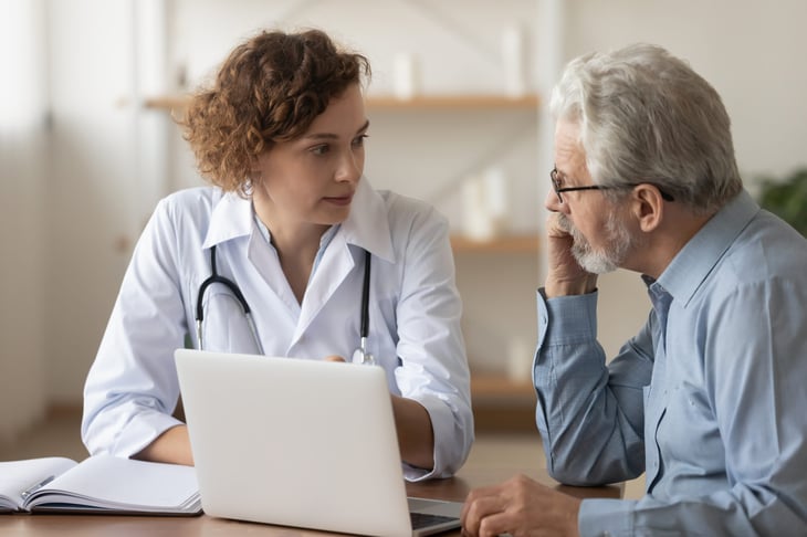 doctor explaining care to senior man