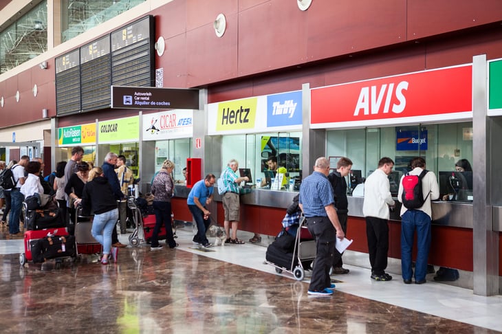 Customers lined up at rental car counters in the airport in Spain