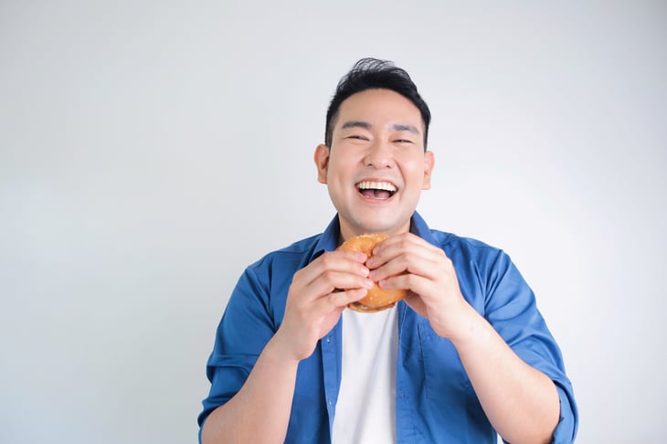 Man eating chicken sandwich.
