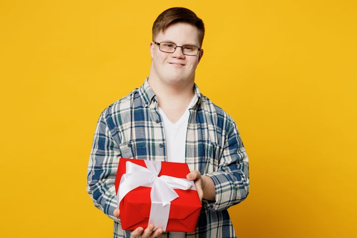 Happy man holding a wrapped gift box