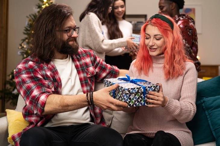 Young people exchanging Christmas gifts