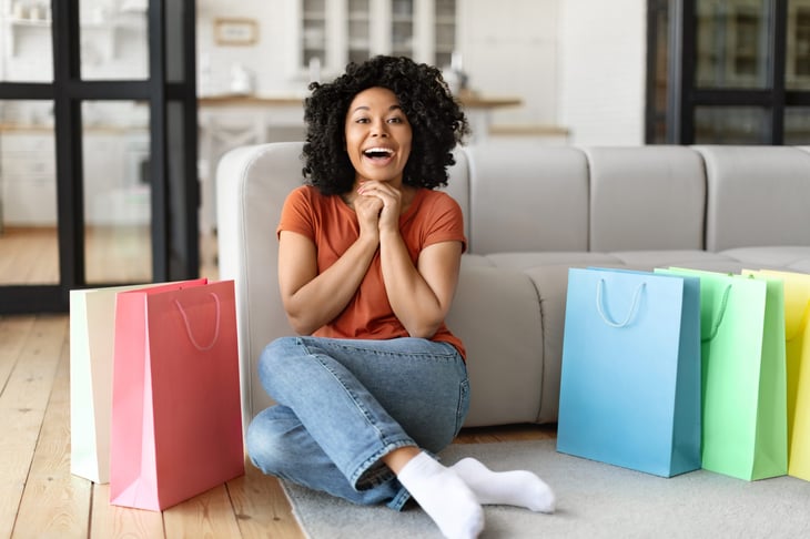 Woman sitting next to shopping bags