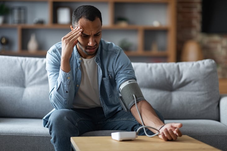 Confused man taking his blood pressure