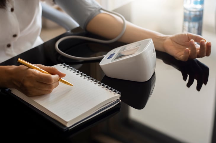 Person taking their blood pressure at home