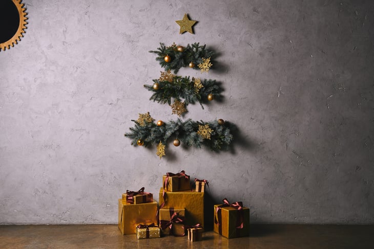 Handmade Christmas tree hanging on a wall, and gift boxes on the floor