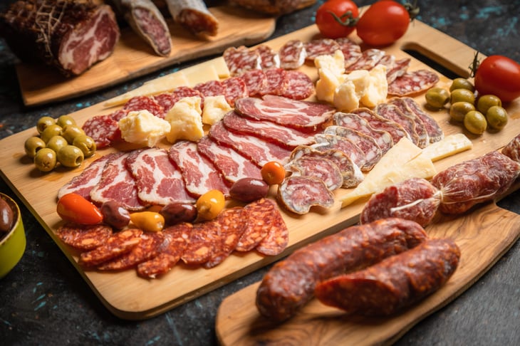 Charcuterie board with various cured meats and sausages