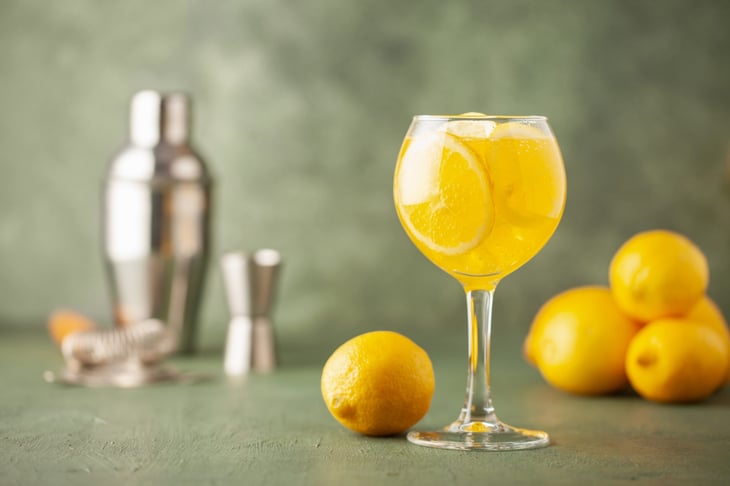 Homemade Limoncello spritz drink of liqueur, sparkling wine and lemon in cocktail glass