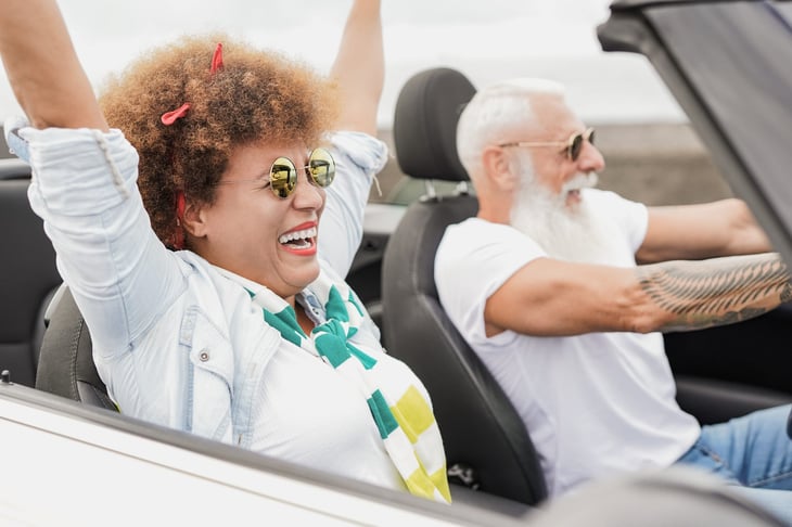Senior couple excited driving down the coast of Florida in retirement or on vacation