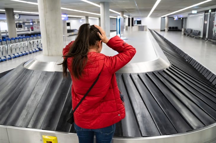 Upset woman at an empty baggage claim