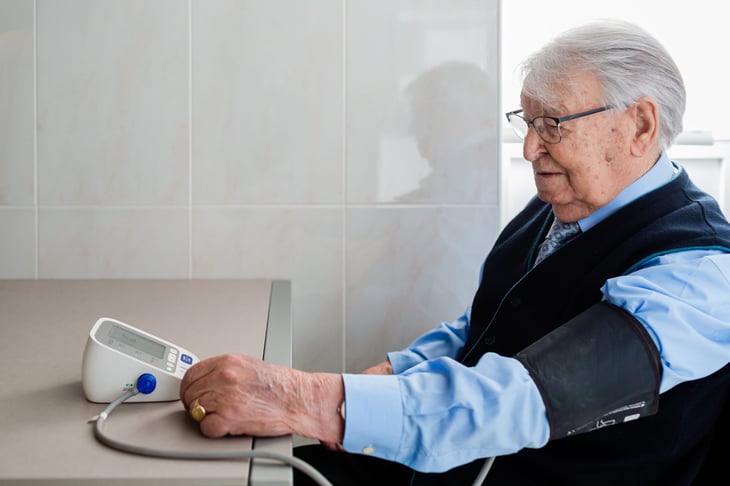 Patient taking blood pressure over a shirt sleeve