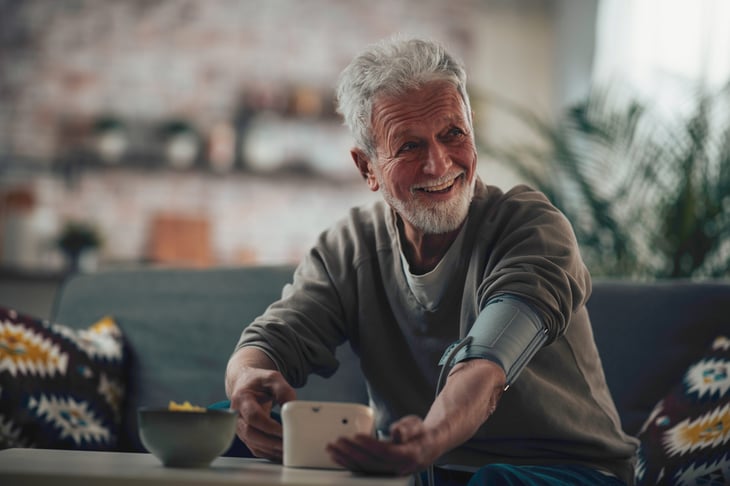 Patient taking his blood pressure at home