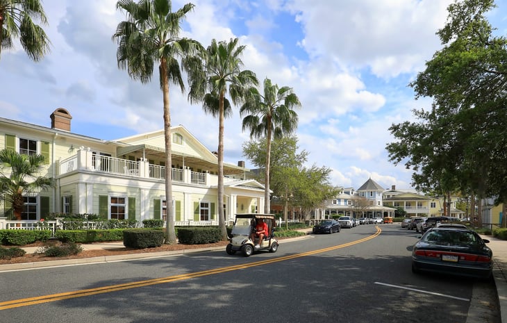 Resident drives a golf cart down main street in The Villages, a popular retirement community in Florida.