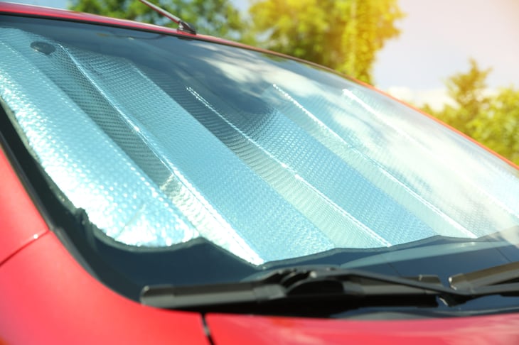 Reflective sun shade in a car's windshield to protect from heat and sun damage