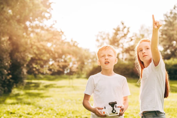 Kids with drone looking up