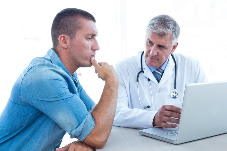 Worried man in middle age talking to his doctor