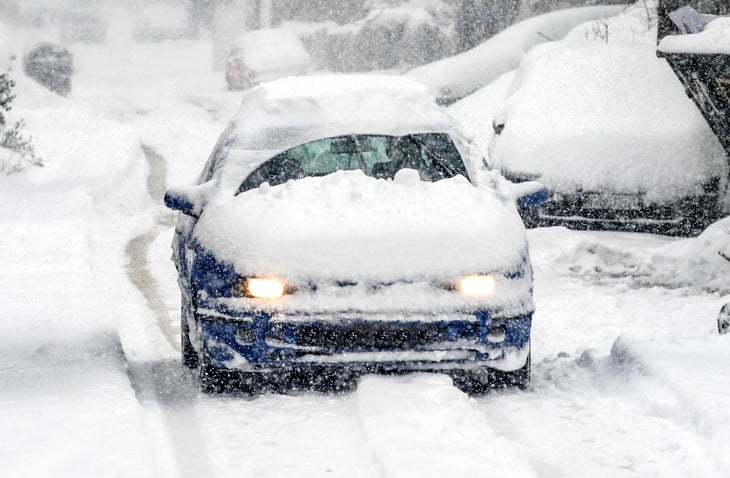 Driving a car covered in snow and ice