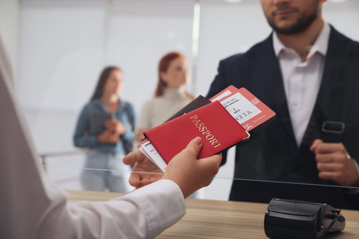 Handing over passport and plane tickets at airport customs or border security