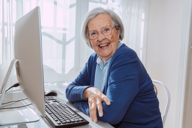 happy senior woman using computer
