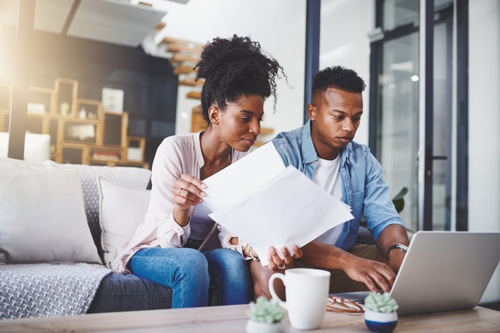 young couple working on taxes paying bills