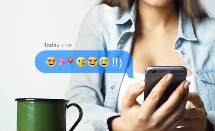 Woman texting with many emojis