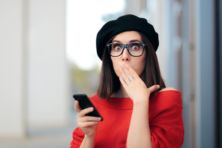 Shocked woman texting