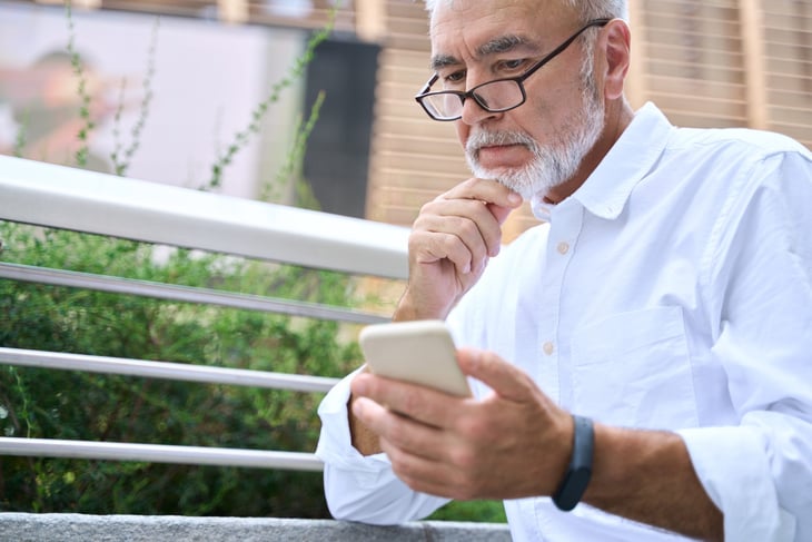 Rich man looking at his phone