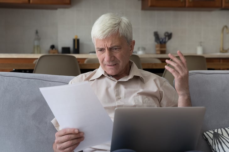 Older man surprised shocked sad about notice