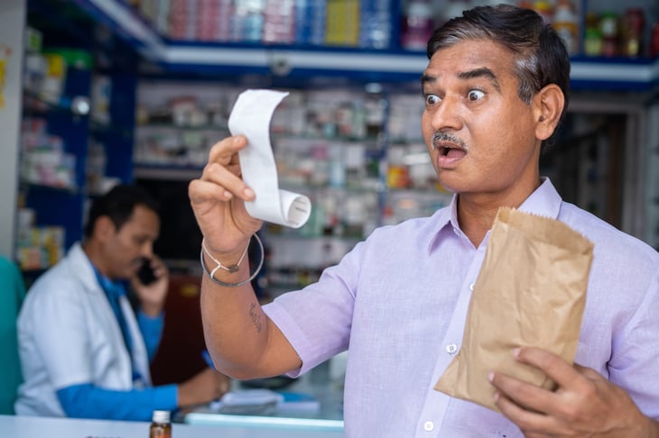 Older man at the pharmacy shocked by prescription price