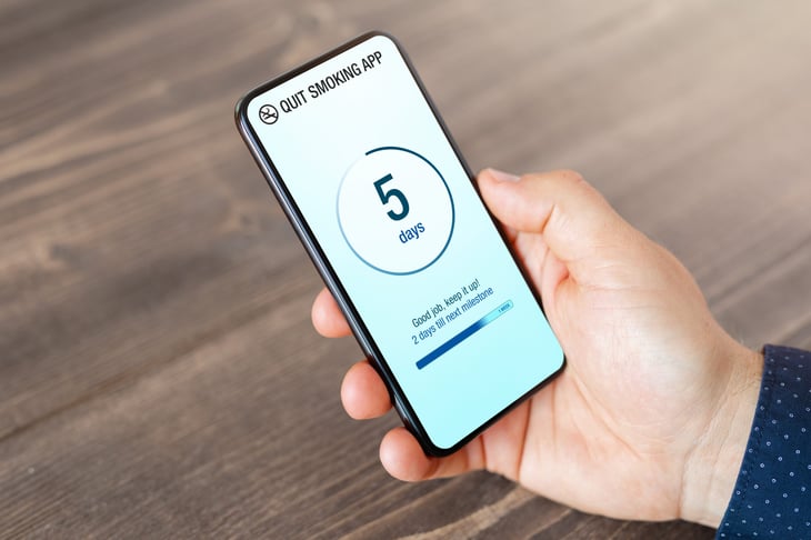Man using mobile app to quit his smoking habit