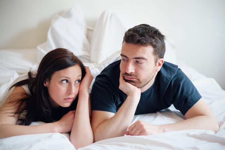 Worried couple in bed