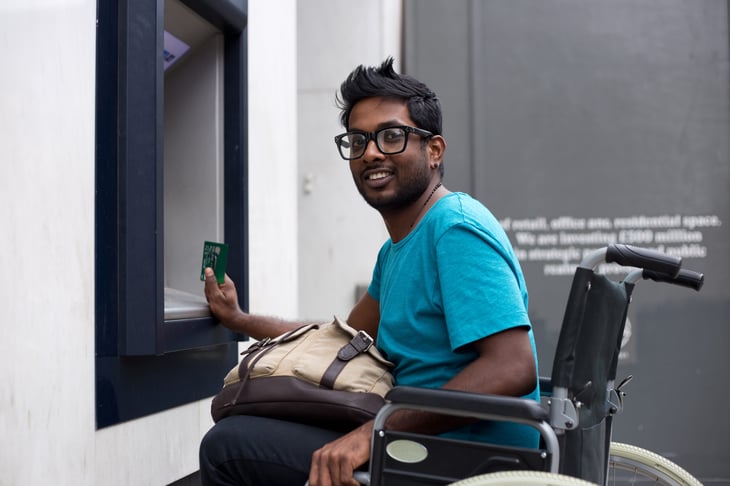 man in wheelchair at ATM