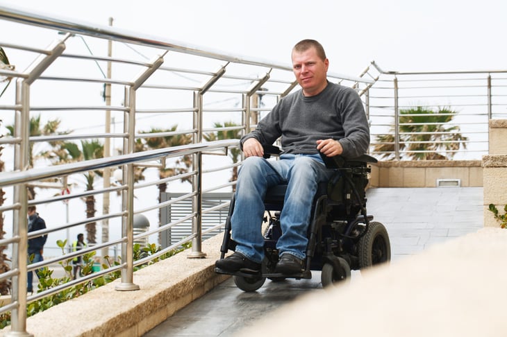 Man in a motorized wheelchair outdoors