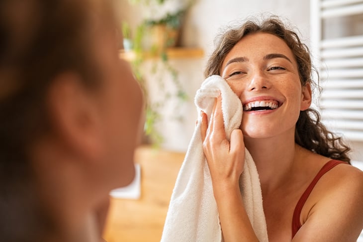 Young woman washing her face