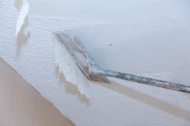 Home owner removing popcorn ceiling.
