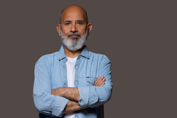 Older man with his arms crossed.