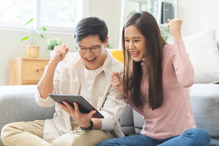 young couple excited about online news