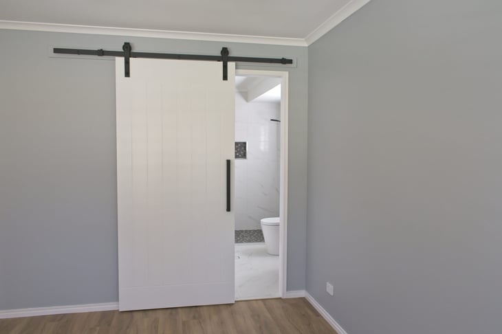Bathroom with a sliding barn door