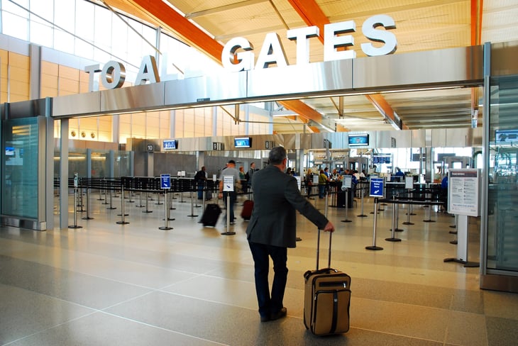 Travelers at airport security carry-on bag