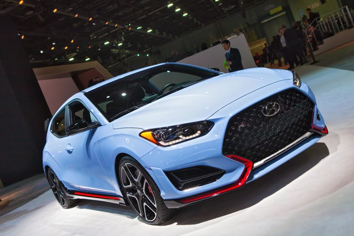 Hyundai Veloster N on display at a car show, at a dealership.