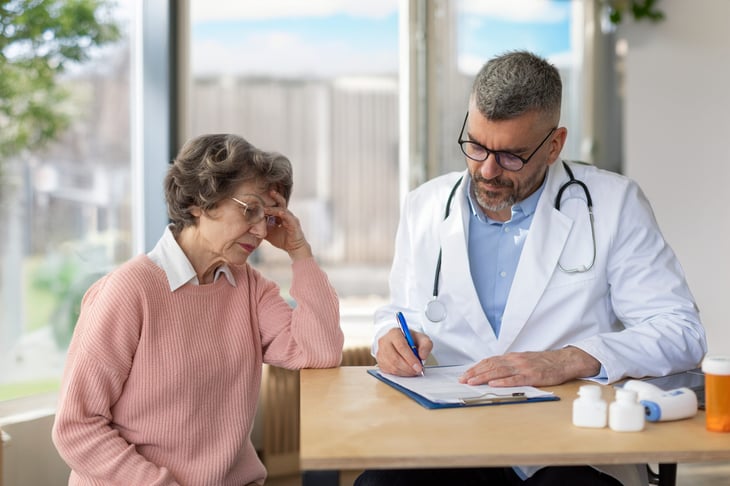 unhappy senior woman listening to doctor