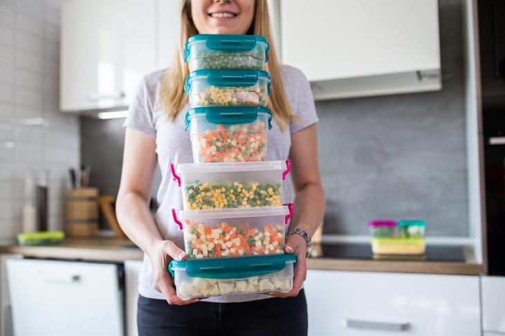 woman with veggies in plastic containers