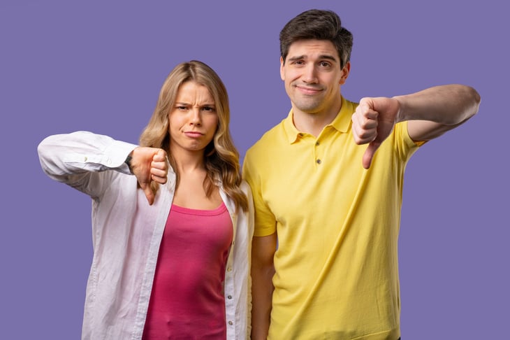 couple with thumbs down